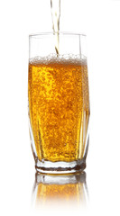 Juice pouring into glass isolated on white