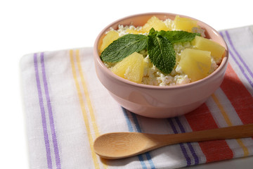 Bowl of tasty cottage cheese with pineapple, close up