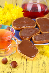Bread with sweet chocolate hazelnut spread on plate on table