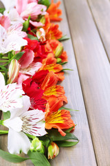 Beautiful Alstroemeria flowers on wooden table
