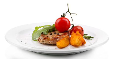 Grilled steak with fried potato pieces and grilled vegetables,