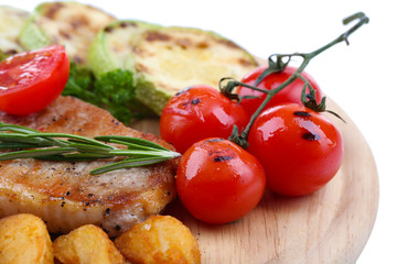 Grilled steak with fried potato pieces and grilled vegetables