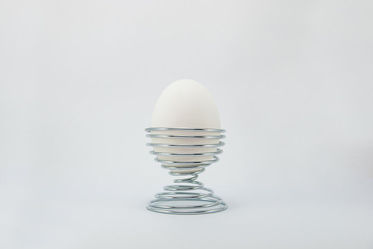 White egg on metal stand holder