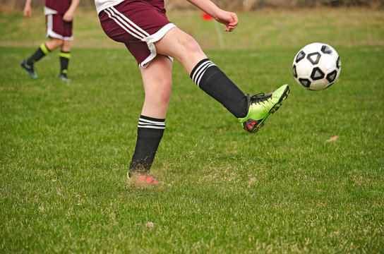 soccer player kicking a ball