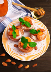 Tasty pumpkin muffins on wooden table