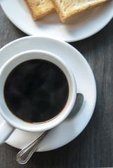 Coffee and  toast on wooden table