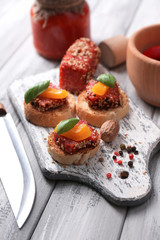 Composition of knife,  tasty sandwiches with salami sausage,