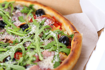 Pizza with arugula, close-up