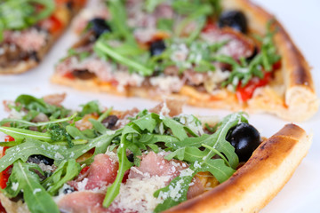 Pizza with arugula isolated on white