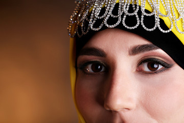 Beautiful muslim arabic woman on dark color background
