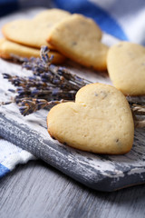 Lavender cookies on cutting board, on color napkin background