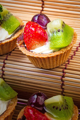 Mini fruit tart and wooden background
