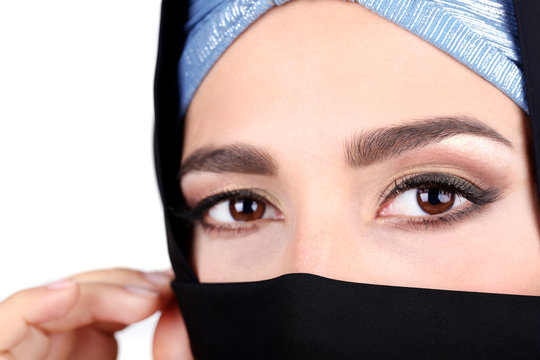 Beautiful muslim arabic woman in paranja on grey background