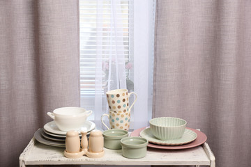 Different tableware on shelf in the interior