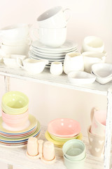 Different tableware on shelf, isolated on white