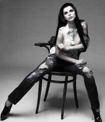 beautiful brunette, sitting on a brown wooden chair