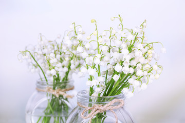 Beautiful lilies of the valley in glass vases