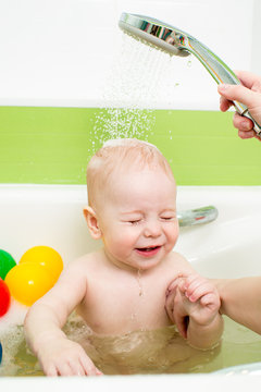 baby taking bath with tempering douche