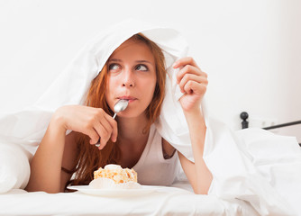  girl eating biscuit in her bed