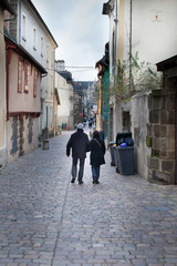 Couple walking in a street, Dinan, Cotes-D'Armor, Brittany, Fran