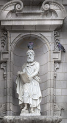 Fototapeta premium Sculpture of St. Matthew on the front facade of a cathedral, Cat