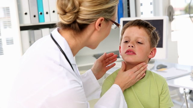 Doctor checking little boys glands