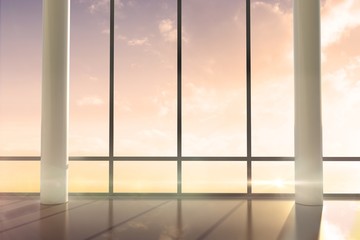 Room with large windows showing sunrise