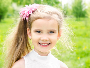 Portrait of adorable smiling little girl on the meadow