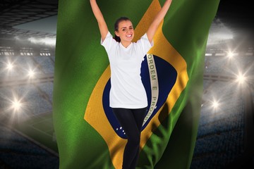 Excited football fan in white cheering holding brasil flag