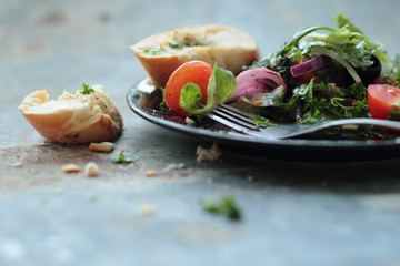 Healthy salad made of fresh vegetables with crunchy baguette