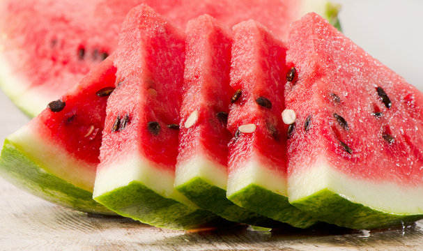 slices of watermelon on wooden table