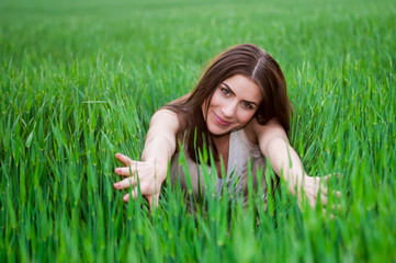 Healthy Smiling Girl in Green Grass.