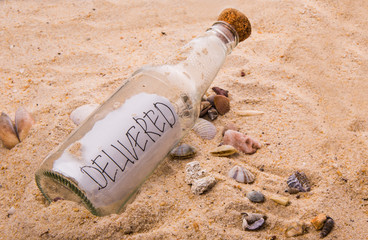 Concept image of a messsage DELIVERED in a bottle