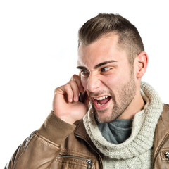 Young businessmen shouting to mobile over isolated background.