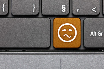 Confused. Orange hot key emoticon on computer keyboard.