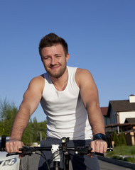 Young man riding bike in countryside 