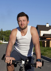 Young man riding bike in countryside 