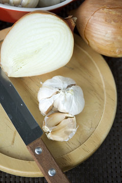 onion and garlic on board