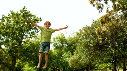 Little boy jumping up and down - Powered by Adobe