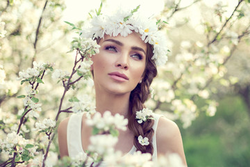 Fototapeta premium Portrait of young beautiful woman in the garden
