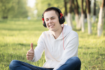 Young attractive man in headphones outdoor