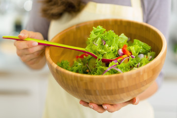 Closeup on young housewife with salad