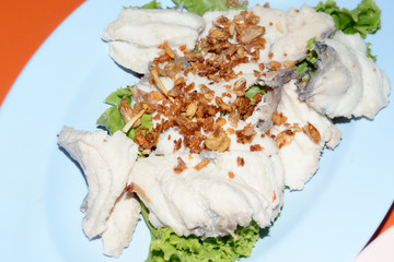 Closeup of Poached fish with fried sliced garlic