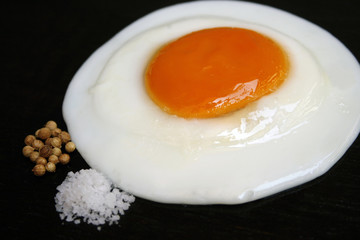 Fried egg with salt and pepper