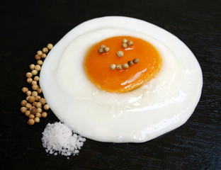 Fried egg with salt and pepper