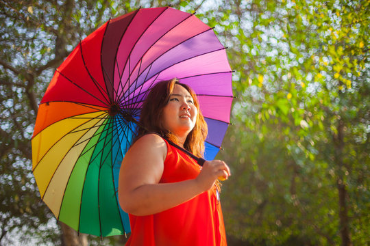 Happy fatty woman with umbrella