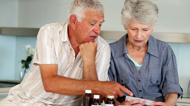 Senior Couple Organizing Their Medicine For The Week