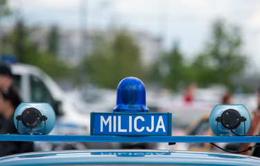 Polish Milicja (Old Police) sign on a old car - obrazy, fototapety, plakaty