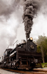 Fototapeta na wymiar Old steam engine blowing smoke.