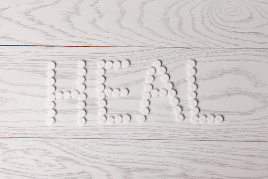 Word heal made of pills on table